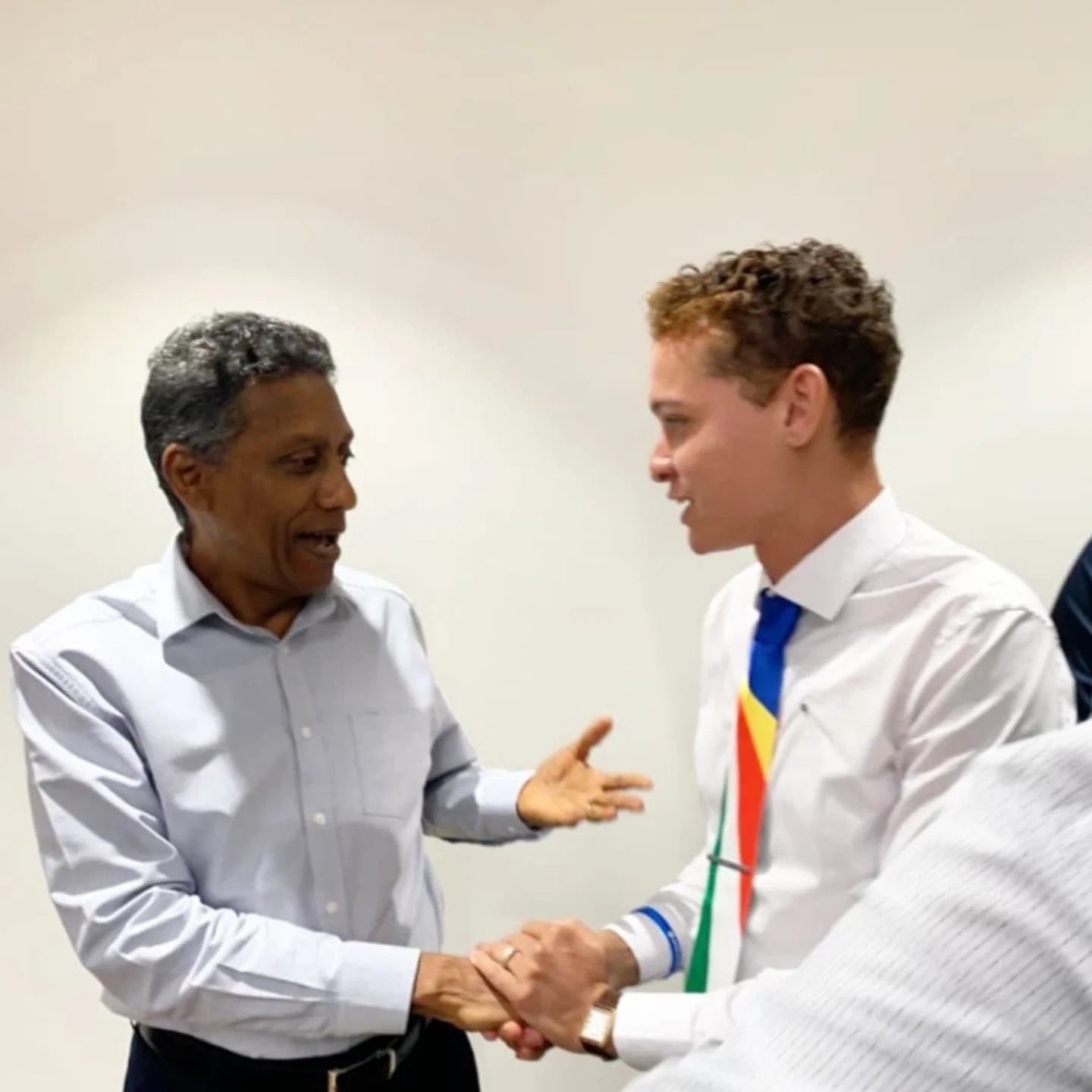 Salim Mathieu shaking hands with former President Danny Faure
